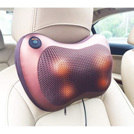 Car & Home Massage Pillow strapped to the headrest of a cream car seat