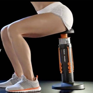 Person using a standing desk with a black and orange SIVA MERC device on a dark background