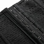 Close-up of a black waist trainer with hooks on a white background