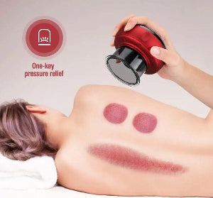 Person receiving cupping therapy with a red and black device on a plain background