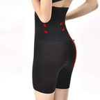 Black shapewear with red accents worn by a person on a white background